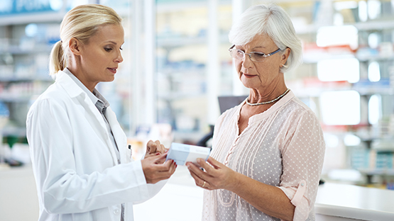 A woman talks with her pharmacist.